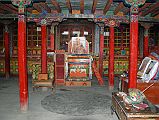 Mustang Lo Manthang 03 03 Chyodi New Gompa Inside The newer Chyodi gompa contains dozens of beautifully crafted small bronze, brass and copper statues, many said to have been cast in Lo Manthang itself. A photo of the tenth Panchen Lama sits on the throne.
